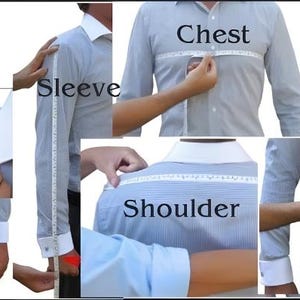 May include: A light blue dress shirt with white cuffs is shown with measurements being taken for length, sleeve, chest, shoulder, waist, and bottom. The shirt is being measured with a white measuring tape.