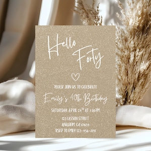 May include: A gold glitter-textured invitation card with the words "Hello Forty" in white script. The card includes details for Emily's 40th birthday celebration, including date, time, and location. A small white heart is also included.