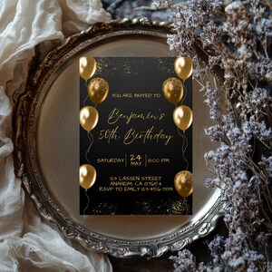May include: A black birthday invitation with gold text and balloons. The invitation reads "You are invited to Benjamin's 50th Birthday" with the date and time. The RSVP information is also included.