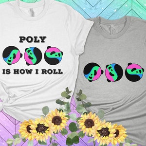 Op de afbeelding: Twee T-shirts met een grafisch ontwerp van drie panda gezichten met een yin-yang ontwerp. Het witte T-shirt heeft de tekst "POLY IS HOW I ROLL" erop gedrukt. Het grijze T-shirt heeft de panda gezichten erop gedrukt.