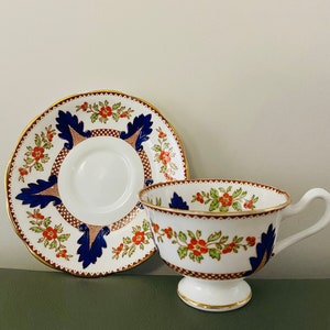 20% sale   Vintage Royal Albert  crown china tea cup and saucer with blue and red hand paint and gold trim.