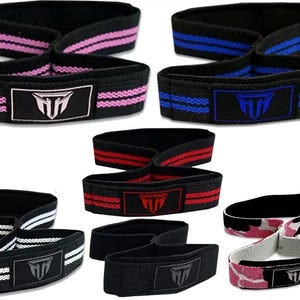 May include: Set of six different coloured fitness straps with a black logo that says "MH". The straps are made of a stretchy material and have a double loop design.