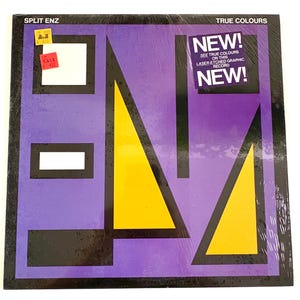 May include: A Split Enz "True Colours" vinyl record. The album cover has a geometric design with purple, yellow, black, and white shapes. The record is labelled "NEW!" and "SALE".