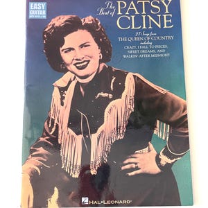 May include: A vintage Patsy Cline songbook featuring a portrait of the singer. The cover displays the text "The Best of Patsy Cline" and "Easy Guitar", with song titles including "Crazy" and "Sweet Dreams". Published by Hal Leonard.