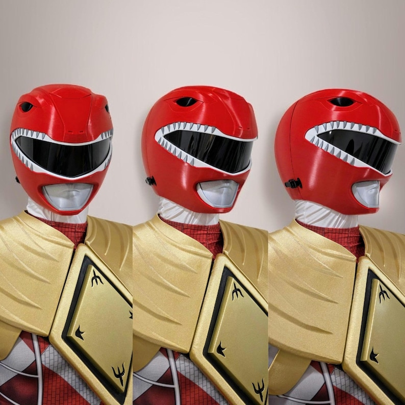 May include: Three red plastic Power Ranger helmets with white accents and black visors. The helmets have a dinosaur tooth design on the front.