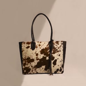 Spacious Large Cowhide Tote Bag with fringe! A Western Cowhide Purse perfect as a Cowhide Tote Shoulder Bag. Genuine Cowhide Leather Purse Bag, an ideal gift.