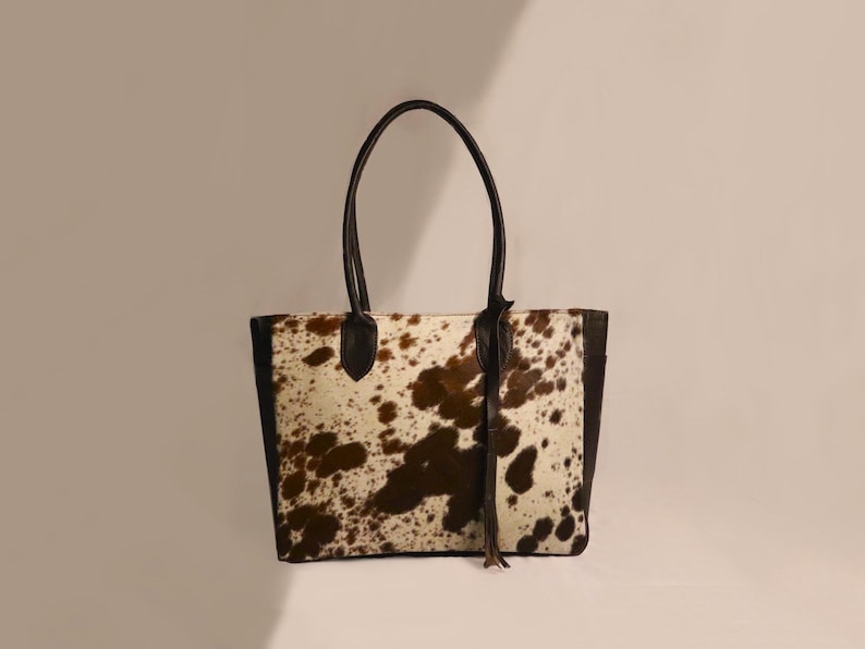 Spacious Large Cowhide Tote Bag with fringe! A Western Cowhide Purse perfect as a Cowhide Tote Shoulder Bag. Genuine Cowhide Leather Purse Bag, an ideal gift.