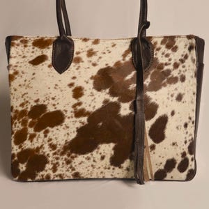 Spacious Large Cowhide Tote Bag with fringe! A Western Cowhide Purse perfect as a Cowhide Tote Shoulder Bag. Genuine Cowhide Leather Purse Bag, an ideal gift.