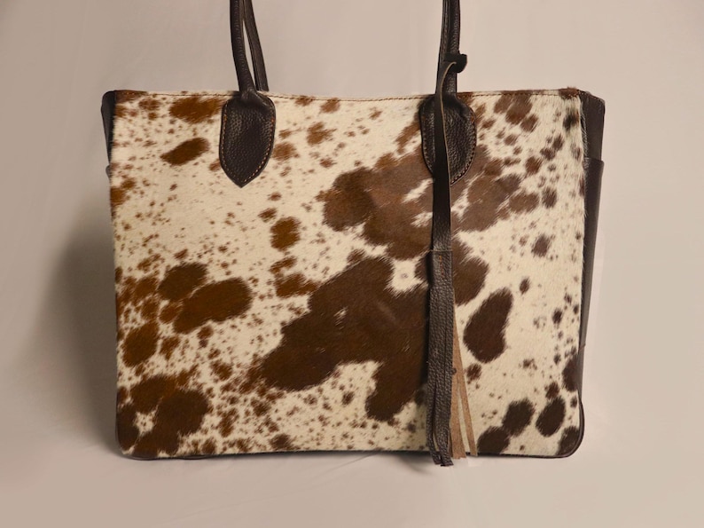 Spacious Large Cowhide Tote Bag with fringe! A Western Cowhide Purse perfect as a Cowhide Tote Shoulder Bag. Genuine Cowhide Leather Purse Bag, an ideal gift.