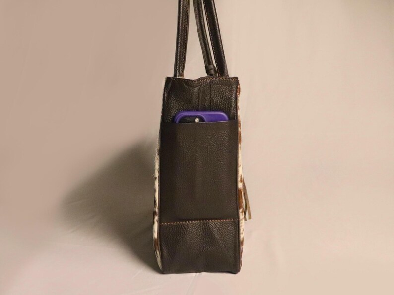 Spacious Large Cowhide Tote Bag with fringe! A Western Cowhide Purse perfect as a Cowhide Tote Shoulder Bag. Genuine Cowhide Leather Purse Bag, an ideal gift.
