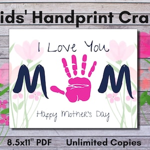 May include: Printable craft for Mother's Day featuring a pink handprint with the words "I Love You" and "Mom" in navy blue. The design is surrounded by pink and white flowers. The text "Happy Mother's Day" is written below the handprint. The printable is 8.5 x 11 inches.