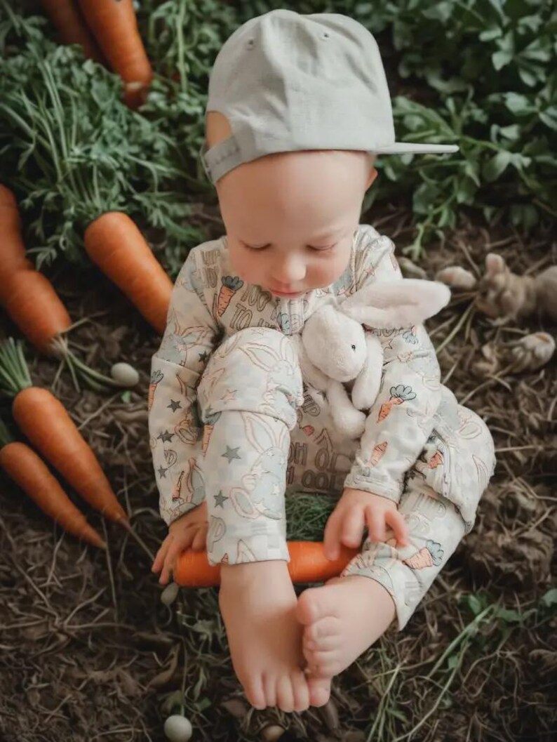 Adorable Baby Boy Easter Bunny Sleepers made with soft, cozy fabric, perfect for infants and toddlers. These Soft Infant Spring Pajamas for Newborns Toddlers and Holiday Photos create cute bunny outfit ideas for Easter celebrations.