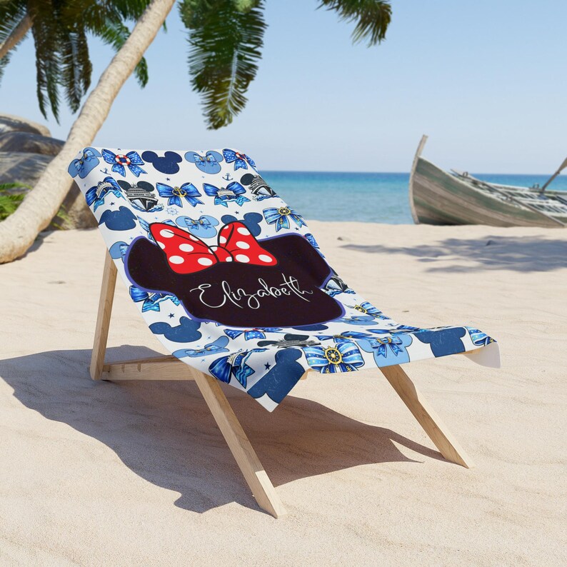 Kids personalized cruise ship towel with Minnie Mouse inspired design in cheerful red and blue tones. Plush absorbent fabric makes it perfect for drying off after swimming, splash pads, and relaxing on deck during vacations.
