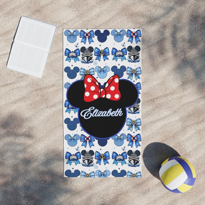 Custom Minnie Mouse themed cruise towel designed for kids with vibrant red and blue accents and personalized name detail. Ideal for Disney cruise poolside lounging, swim lessons onboard, and fun family vacation photo moments.