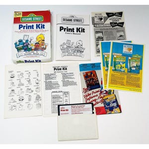 May include: A collection of Sesame Street Print Kit items, including a box, user manual, and various print materials. The box features Sesame Street characters and the text "Print Kit." Other items include graphics and software advertisements.
