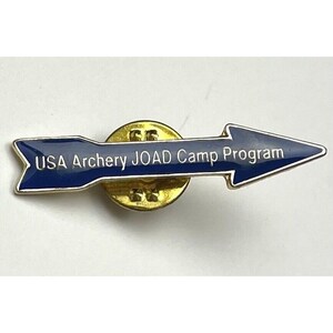 May include: A blue and gold arrow-shaped pin with the text "USA Archery JOAD Camp Program" on it.