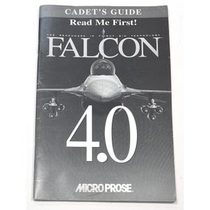 May include: A black and white image of a fighter jet with the text "CADET'S GUIDE Read Me First!" and "FALCON 4.0" on the cover of a booklet. The text "THE BENCHMARK IN FLIGHT SIM TECHNOLOGY" is also visible. The booklet is from MicroProse.