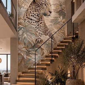 May include: A large-scale wall mural featuring a leopard positioned among tropical palm leaves and foliage, set against a backdrop of a circular sun. The mural is displayed on a tall wall behind a wooden staircase with integrated lighting.