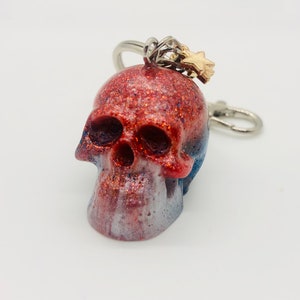 Handmade red, white, and blue resin skull keychain with matching star charms