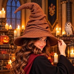 May include: A brown crocheted pointed hat with a wide brim and a slumped, textured crown. The hat features a dense, ribbed knit pattern throughout, creating a structured yet flexible shape that curves slightly at the top point.