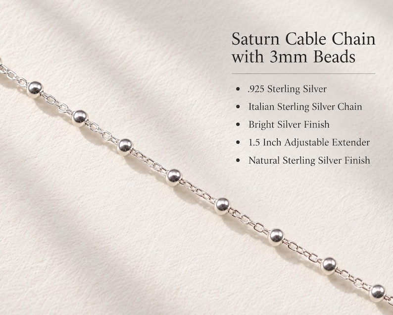 May include: A Saturn cable chain with 3mm beads made of .925 sterling silver. The chain features a bright silver finish and a 1.5 inch adjustable extender. The text reads: Saturn Cable Chain with 3mm Beads, .925 Sterling Silver, Italian Sterling Silver Chain, Bright Silver Finish, 1.5 Inch Adjustable Extender, Natural Sterling Silver Finish.