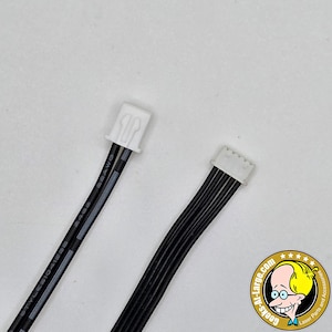 May include: Two black electrical cables with white connectors. One cable has the text "STYLESIO415B 22AWG" printed on it. The other cable has six black wires. The image also includes a logo for "Geeks-R-Large.com".