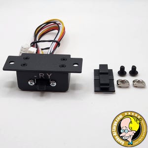 May include: Black electronic component with a toggle switch labeled "-RY". It has a rectangular base with mounting holes and is connected to multi-colored wires. Additional hardware includes a black clip, screws, and nuts.