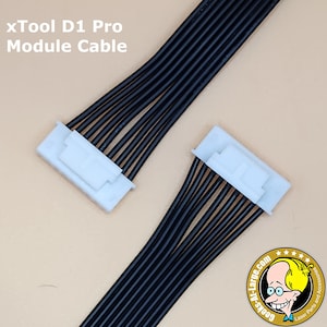 May include: Two black xTool D1 Pro Module Cables with white connectors. The cables are arranged diagonally against a light tan background. The text "xTool D1 Pro Module Cable" is visible in the upper left corner.
