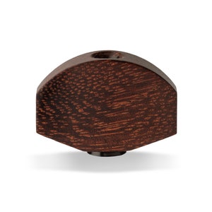 May include: A dark brown wooden guitar tuning peg with a rounded top and a small hole in the centre.