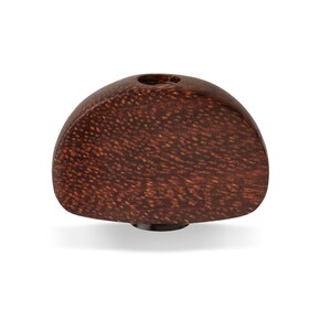 May include: A dark brown wooden guitar tuning peg button.