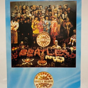 May include: A vintage poster featuring the Beatles' album cover for "Sgt. Pepper's Lonely Hearts Club Band". The poster features a colorful image of the band members surrounded by a variety of people and objects, including flowers, a drum, and a large, circular sign with the album title.
