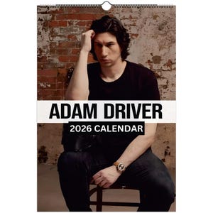 May include: A wall calendar featuring Adam Driver. The calendar has a white banner with the text "ADAM DRIVER" in bold, black letters, and "2026 CALENDAR" below. The background is a brick wall.