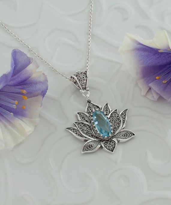 Sterling Silver Round Blue Topaz and Diamond Lotus Flower Pendant Sterling Silver Round Blue Topaz and Diamond Lotus Flower Pendant