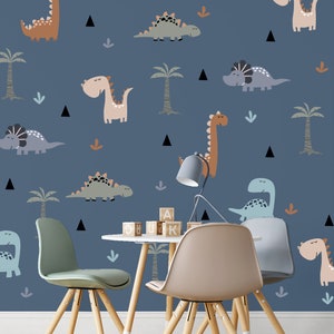 May include: A blue wall with a dinosaur theme. The wall is decorated with various dinosaurs in different colors and patterns. There are two wooden chairs and a table with wooden blocks on it. The table and chairs are in front of the wall.