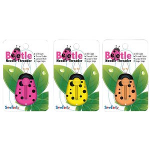 May include: Three colorful Beetle needle threaders in pink, yellow, and orange. Each threader has black spots and a yellow thread cutter. The packaging includes the text "Beetle Needle Threader" and "SewTasty".