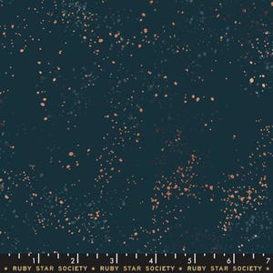 May include: Dark teal fabric with a speckled pattern of small, irregularly shaped dots in shades of orange and gray. The fabric has a dense, all-over design, with the dots appearing to float against the dark background. The text "RUBY STAR SOCIETY" is at the bottom.