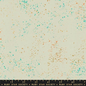 May include: A beige fabric with a speckled pattern of teal, orange, and gold dots. The fabric is a light weight and has a soft hand.