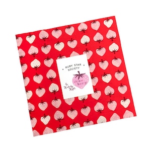 May include: A square fabric piece with a repeating pattern of pink and white strawberries on a red background. A white card with the text "RUBY STAR SOCIETY" and "strawberry" is placed on top.