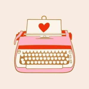 May include: A pink typewriter with a red heart on the paper in the carriage. The typewriter has a gold outline and a white keyboard.