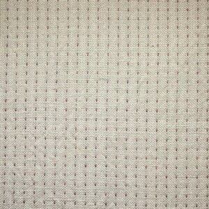 May include: Close-up of a beige fabric with a grid pattern of small, dark red dots. The fabric has a woven texture, with visible threads creating a subtle, textured surface. The dots are evenly spaced.