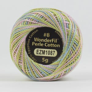 May include: A ball of WonderFil Perle Cotton thread in pastel colors of pink, yellow, and blue. The label reads "#8 WonderFil Perle Cotton" and "EZM1087". The thread is 100% Egyptian Cotton and weighs 5g.