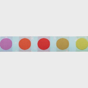 May include: Close-up of a ribbon with a repeating pattern of colorful polka dots. The dots are in shades of purple, orange, red, gold, and yellow. The background is a light blue with white stars.