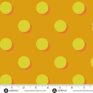 May include: Mustard yellow fabric with a repeating pattern of large, lime green circles. Each circle has a reddish-orange shadow, creating a 3D effect. The fabric is marked with a ruler along the bottom edge, indicating measurements in inches.