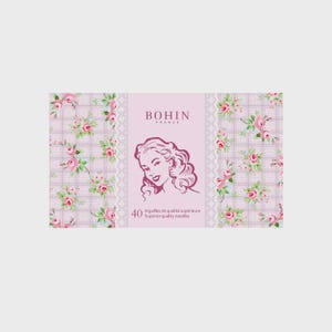 May include: A pink and white floral patterned box with a white lace border. The box contains 40 Bohin superior quality needles. The box features a vintage illustration of a woman with a pink background.
