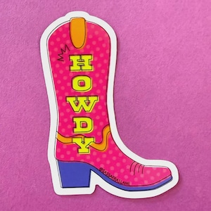 May include: A sticker featuring a pink cowboy boot with white polka dots. The boot has a blue heel and the word "HOWDY" in yellow block letters. The sticker has a white border and the text "@SASSAFRASLANE" is at the bottom.