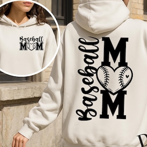 May include: Cream-colored hoodie with the text "Baseball MOM" in black. The design includes a baseball-stitched heart. The same design is repeated on the front. A casual, comfortable apparel item.