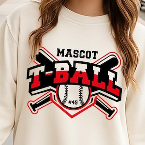 May include: A cream-colored sweatshirt with a graphic design of a baseball with crossed bats and the text "MASCOT T-BALL #45".
