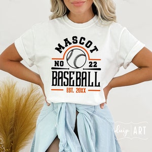 May include: White t-shirt with a black and orange baseball graphic. The graphic says "Mascot No. 22 Baseball Est. 20XX".