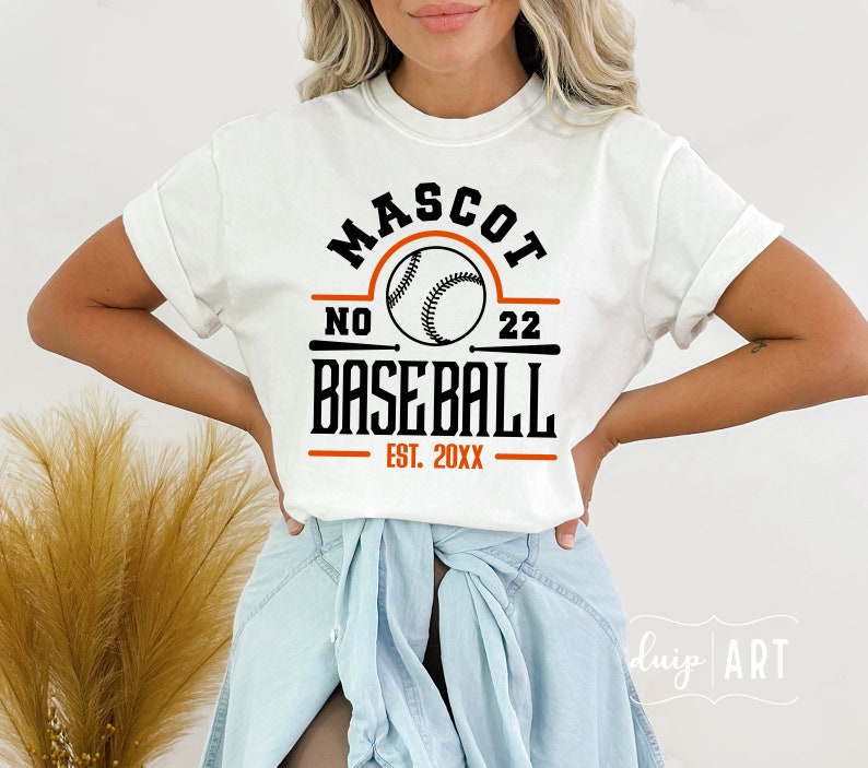 May include: White t-shirt with a black and orange baseball graphic. The graphic says "Mascot No. 22 Baseball Est. 20XX".
