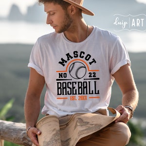 May include: White t-shirt with a black and orange baseball graphic. The graphic says "Mascot No. 22 Baseball Est. 20XX".